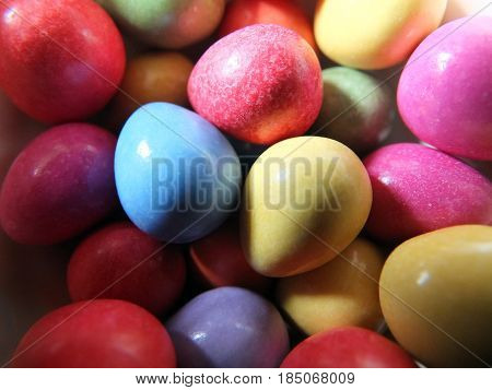 coloured easter egg sweets in yellow purple blue rad and green