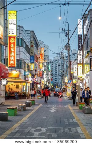 People walking in the street of the Gung-dong shopping and entertainment district at evening Daejeon South Korea 12 March 2017