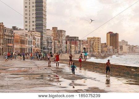 HAVANA CUBA - February 10 2008. People meet sunset after storm at famous embankment promenade Malecon.