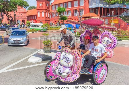 MALACCA, MALAYSIA - AUGUST 12, 2016: The decorated trishaw parking in Dutch Square Malacca tourists and local people can seen around the Dutch Square Malacca