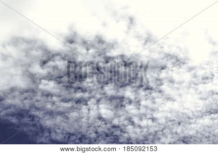 Spindrift clouds are gathering on the darkening  blue autumn sky