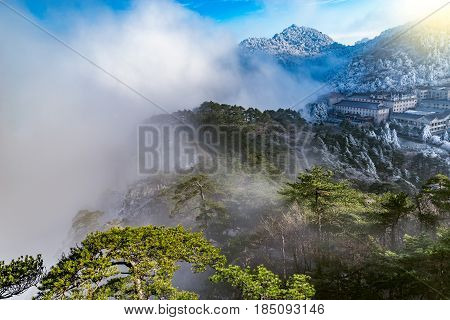 Clouds above the peaks and hotels of Huangshan National park. China.