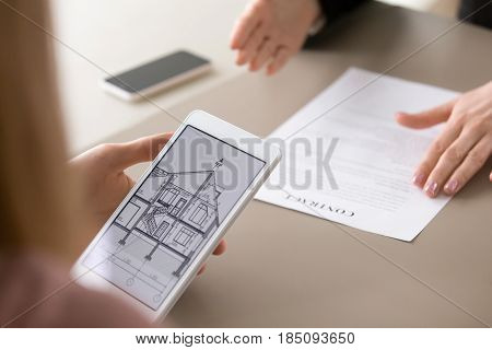 Real estate agency clients holding tablet, looking at architectural plan of dream house, considering mortgage, loan for buying suburban housing. Renters choosing accommodation to lease or rent