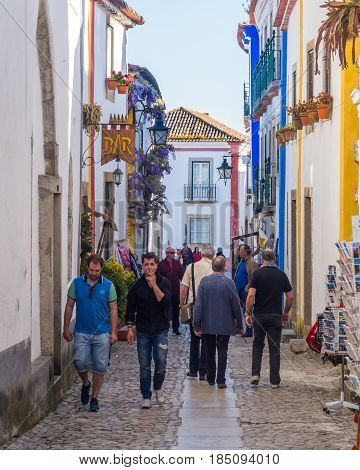 OBIDOS PORTUGAL - APRIL 03 2017: People walking on the main street of Obidos on April 03 2017.
