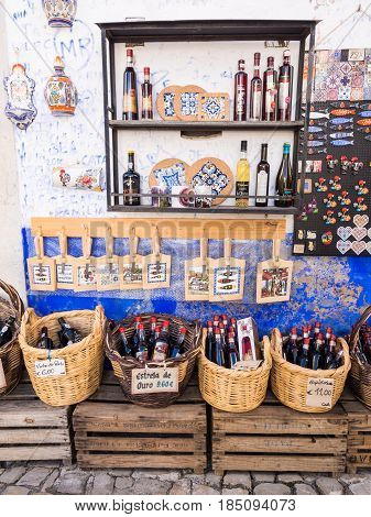 OBIDOS PORTUGAL - APRIL 03 2017: Gift store selling Ginja de Obidos traditional regional cherry liquor.