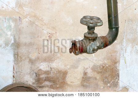Old water faucet with fastening elements of the fire hose
