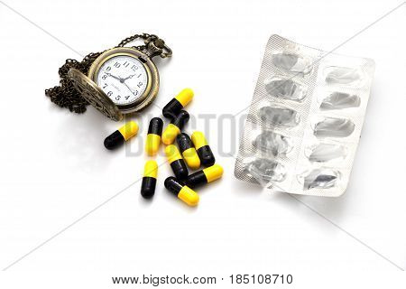 Heap Medicine Capsule, Medicine Pack And Old Silver Pocket Watch Put On White Background. This Image