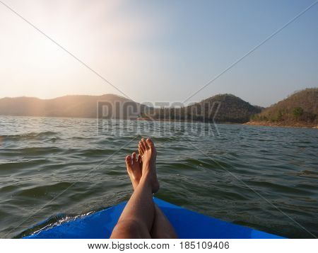 young woman sit relaxing with one's legs crossed. with big rubber pad float on water have scenery seasky and mountain are background. this image for naturetravel and seascape concept