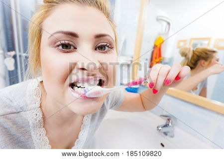Woman Brushing Cleaning Teeth In Bathroom