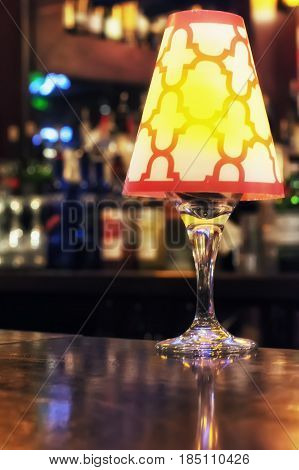 A light fixture sitting on a bar.