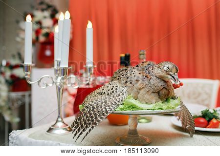 a wounded pheasant hunting. cooked chef to the Banquet. Traditional still life feast.