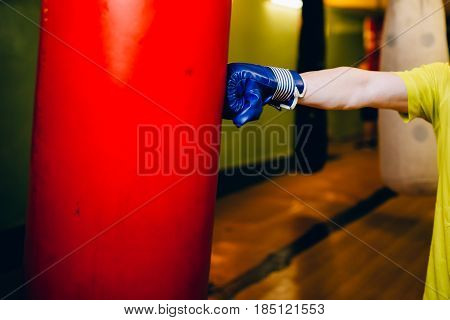 Punching bag in the gym. Against the backdrop of athletes. Gym is a cellar. Russia.