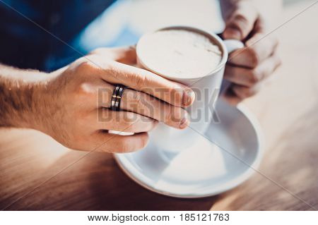 View Of Man Hand Holding A Cup Of Coffee , A Cup Of Coffee And A Man's Hand