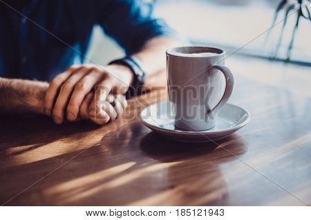View Of Man Hand Holding A Cup Of Coffee , A Cup Of Coffee And A Man's Hand