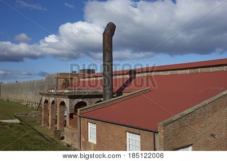 PUERTO NATALES, CHILE - APRIL 10, 2017: Historic buildings of a former meat refrigeration plant that have been renovated and converted into a luxury hotel.