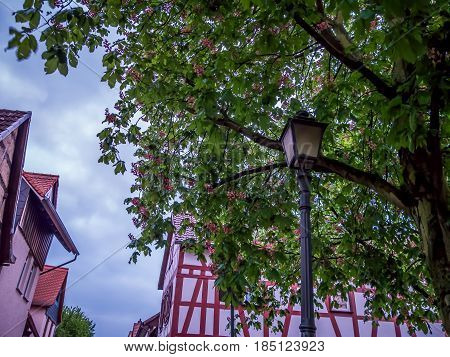 Ancient medieval street lamp in a historic center of a german village