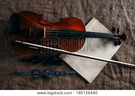 Violin, fiddlestick, notes and bowties closeup
