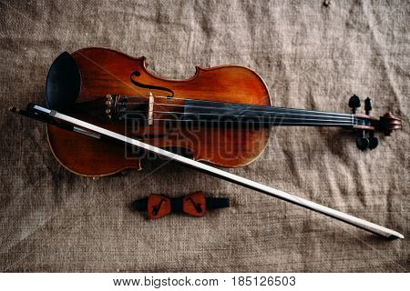 Violin, fiddlestick and bowtie, canvas background