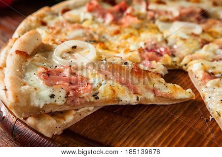 Junk food, bad habits. Pizza sliced on rustic wooden table background. Italian traditional meal