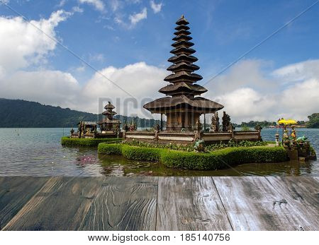 vintage wood terrace with view of Pura Ulun Danu Batur is hindu temple at Bratan lake in Bali Indonesia soft focus selective focus copy space.
