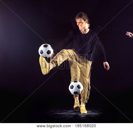 A portrait of a fan with ball on gray studio background. Freestile concept. Stroboscope shooting technique