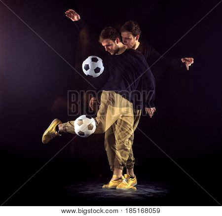A portrait of a fan with ball on gray studio background. Freestile concept. Stroboscope shooting technique
