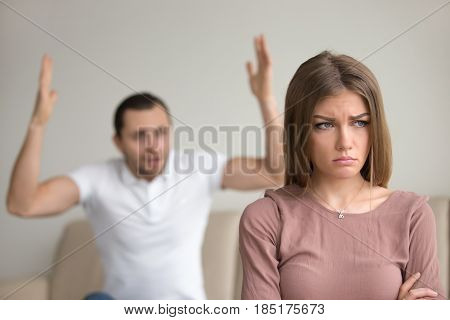 Family couple arguing, mad husband yelling at upset wife, reducing her to tears, sad woman about to cry, feeling aggrieved, marital misunderstandings, temperament clashes in relationships
