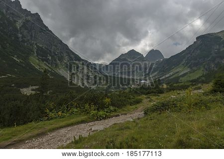 Mountain overgrown with coniferous forest, glade and rest-house toward Maliovitza peak in Rila 

mountain, Bulgaria