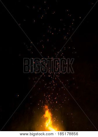 bonfire summer night flames with sparks on a black background