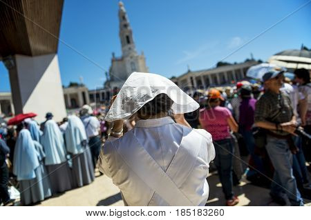 Fatima Portugal - May 13 2014: Crowd of people at the Sanctuary of Fatima during the celebrations of the apparition of the Virgin Mary in Fatima Portugal.