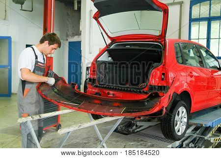 Portrait Of An Auto Mechanic At Work On A Car