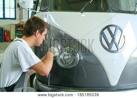 Portrait Of An Auto Mechanic At Work On A Car