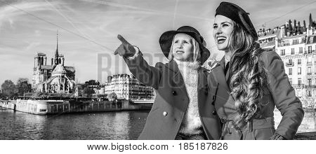 Mother And Daughter Travellers In Paris Pointing At Something