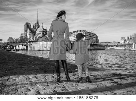 Mother And Daughter Travellers In Paris Pointing At Something
