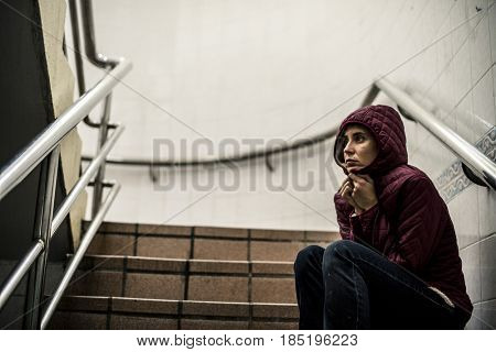 Cold Hopeless Woman Sitting Thoughtful on the Stairway