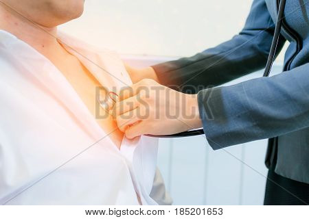 Doctor checking patient heartbeat by using stethoscope