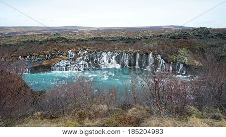 Hraunfossar Horizontal Waterfall In Icealand. Beautiful And Majestic Landscape Tourist Attraction Pl