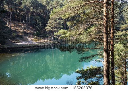 Beautiful Vibrant Landscape Image Of Old Clay Pit Quarry Lake With Unusual Colored Green Water