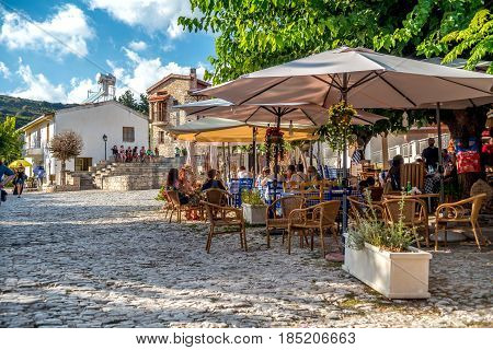 OMODOS CYPRUS - OCTOBER 04 2015: People sitting at an outdoors cafe in Omodos village Limassol District