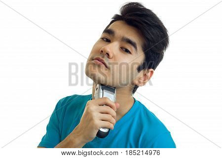 handsome young guy raised his head up and shaves his beard close-up isolated on white background