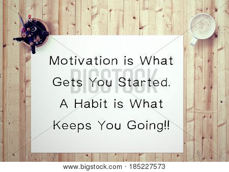 Inspiring motivation quote handwritten on a notepad  motivation is what gets you started. a habit is what keeps you going. White pad paper image.