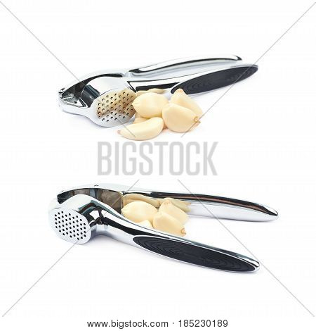 Metal garlic press utensil next to a pile of fresh cloves isolated over the white background, set of two different foreshortenings