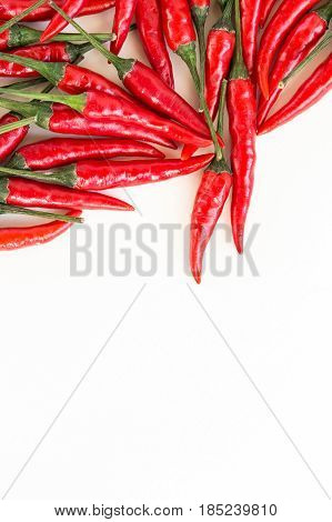 red hot chili peppers, popular spices concept - scattering of red hot chili pepper, laying on white background, top view, flat lay, lot of free space for the text