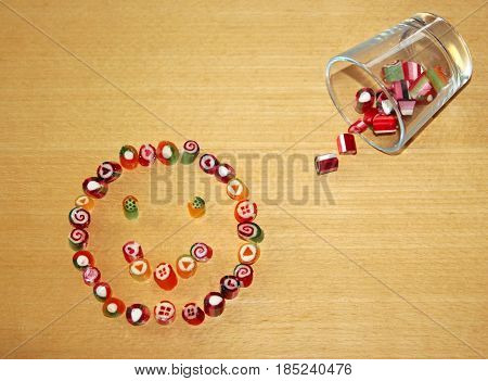 smiley laid with candies on a wood table