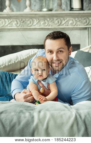 Happy dad with a little daughter of European appearance