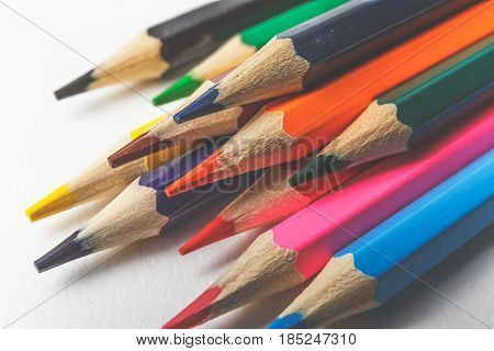 Toned background of colored pencils on white paper for art creativity closeup macro photo