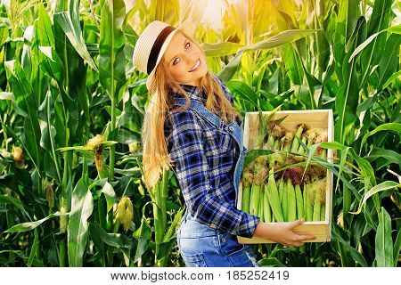 Happy Farmer. Portrait Of Beautiful And Young Smiling Redhaired Girl In Hat And Coveralls Holding A