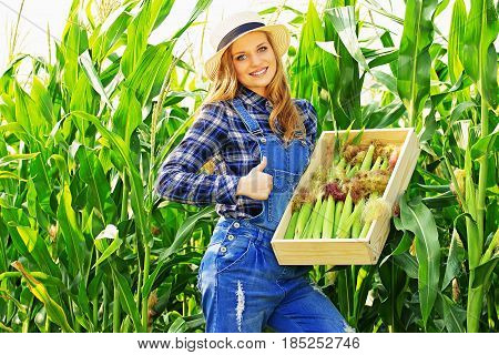 Big Harvest. Portrait Of Young And Attractive Smiling Girl In Hat And Coveralls Showing Big Thumb Up