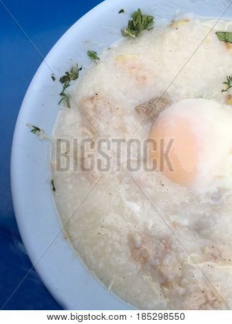 Traditional Thai Porridge Rice Gruel In White Bowl, Congee. In The Street Night Market.