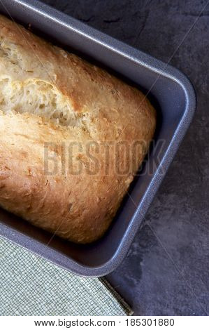 Hot fresh banana bread in a tin from the oven.